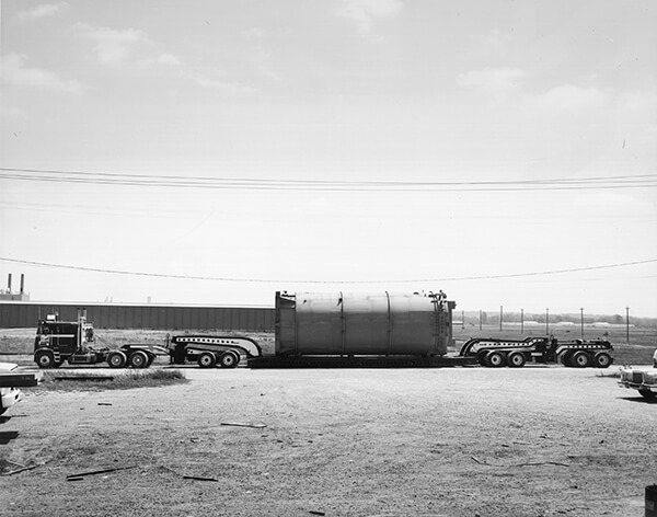 A pressure vessel on a Cozad trailer with nine axles.
