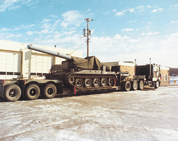 A tank on a double-drop trailer, E. L. Murphy Trucking.